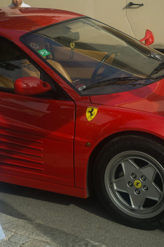 Red ferrari testarossa sports car parked outdoors
