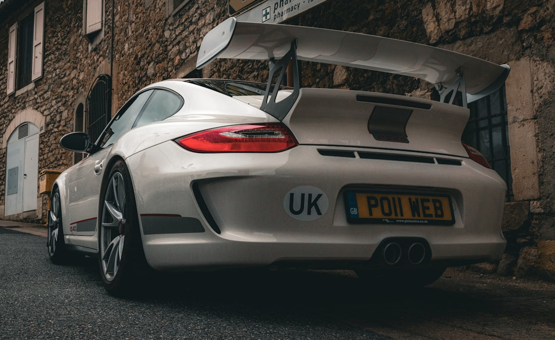 White porsche 911 gt3 with large rear spoiler.
