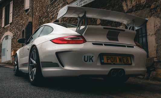 White porsche 911 gt3 with large rear spoiler.