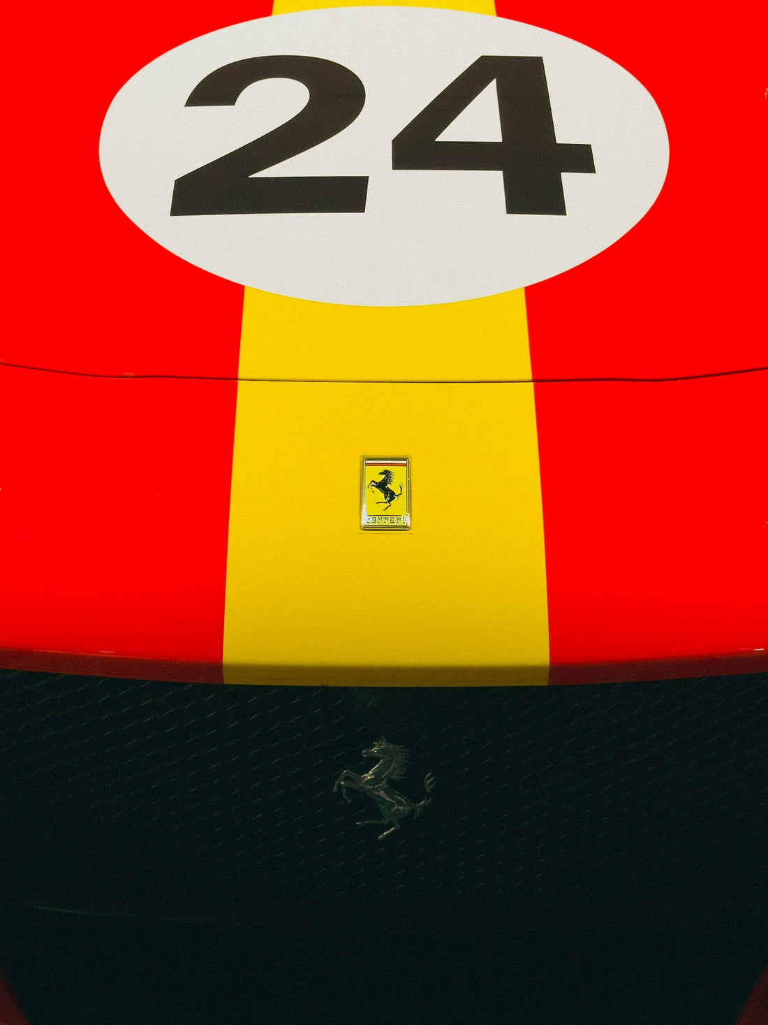 Red and yellow ferrari race car with number 24