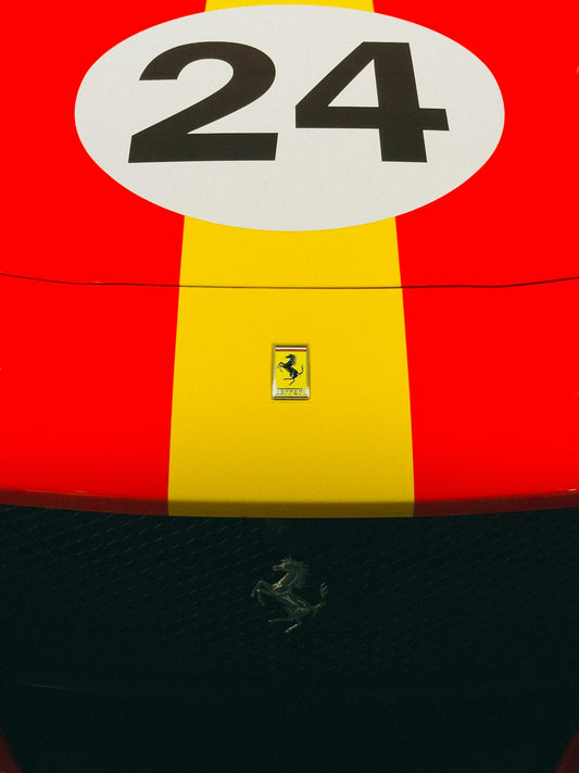 Red and yellow ferrari race car with number 24