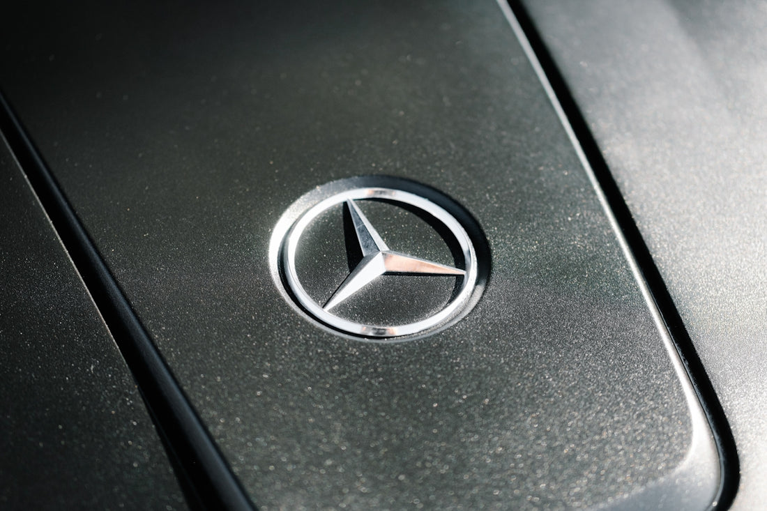 Close-up of a mercedes-benz car emblem on engine