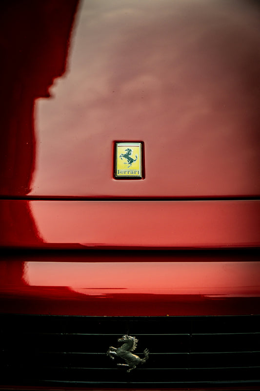 Red ferrari emblem on a car hood