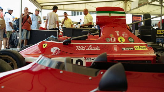 Red vintage ferrari race car with niki lauda text.